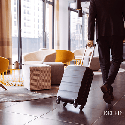 A man with a suitcase walking in Delfines Hotel