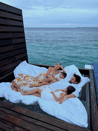 Grand Park Kodhipparu Maldives Family of four enjoying the time together on the hammock at the overwater villa