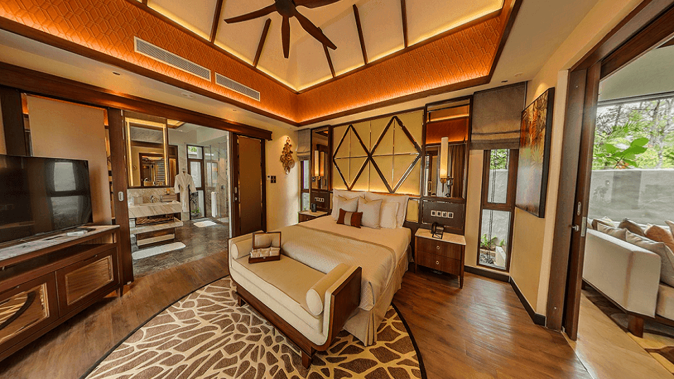 Spacious Grand Garden Villa with king bed, geometric headboard, ceiling fan, and ensuite bathroom at The Banjaran Hotsprings Retreat.
