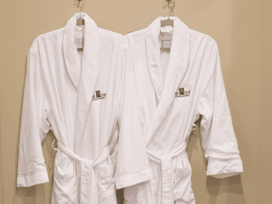 Two white bathrobes on hangers in wall at the inn at Willow grove