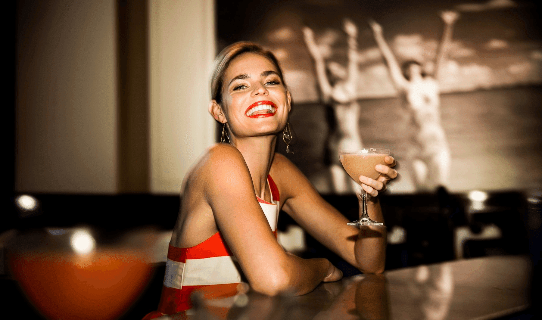 Lady having a cocktail by the Bar counter, The Diplomat Resort