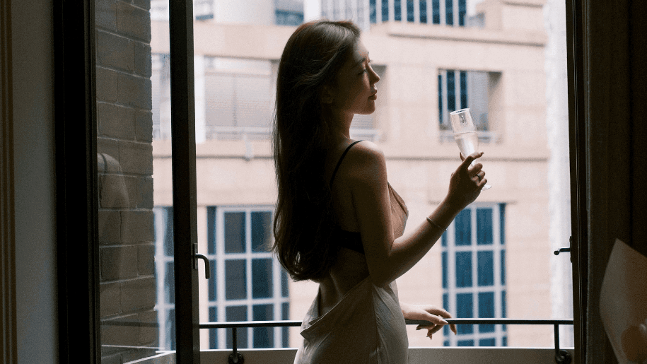 GIRL STANDING BY THE JULIETTE BALCONY