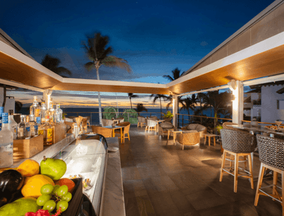 Sky Bar with wicker chairs, bar counter and ocean view at Buenaventura Grand Hotel and Spa