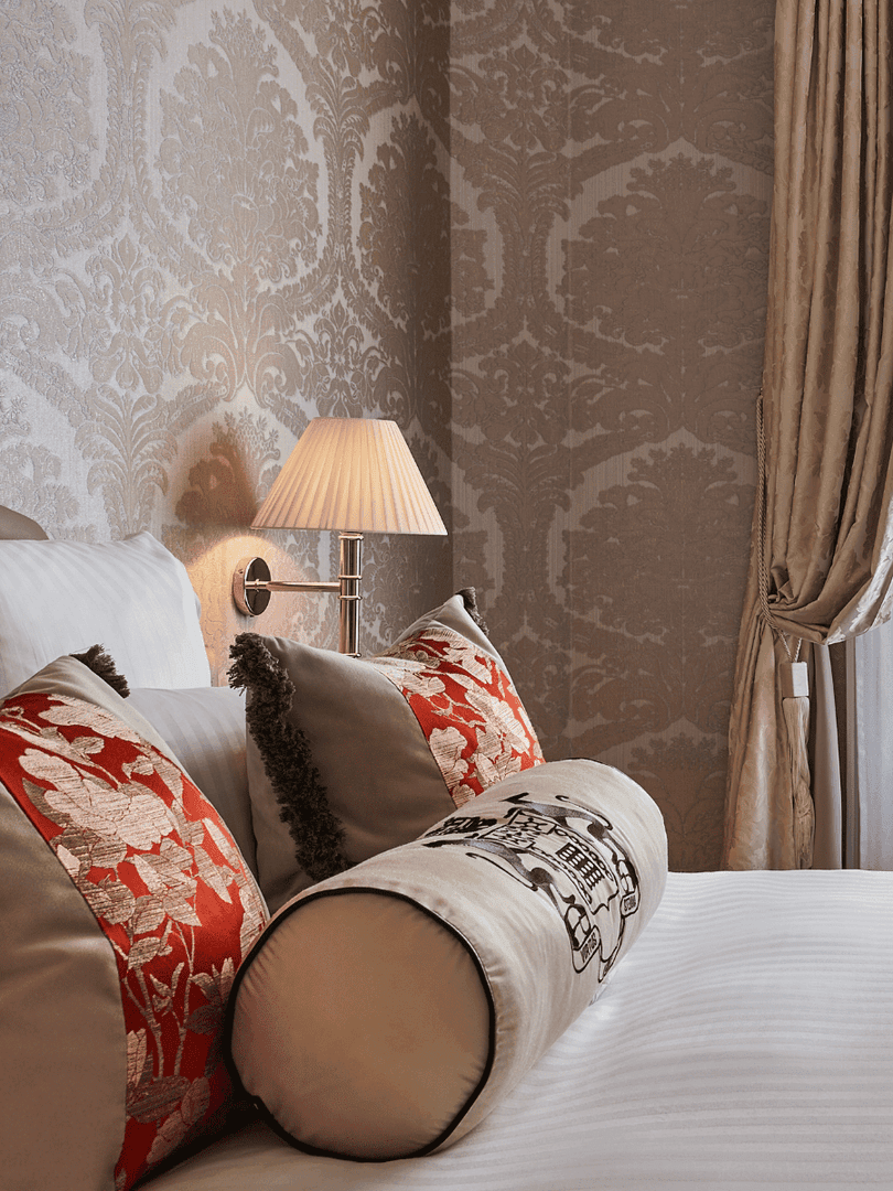 Bed under wall lamp with couch near window in Deluxe Suite Belle Époque at Hotel Westminster Paris
