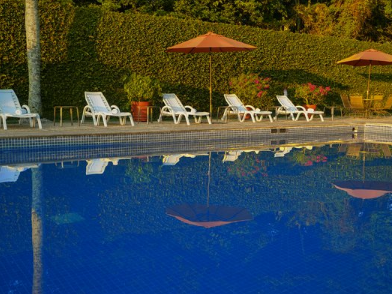 An outdoor swimming pool & sunbeds at Gamma Hotels