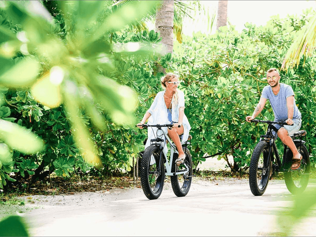 A couple cycling at The Signature Collection by Hideaway