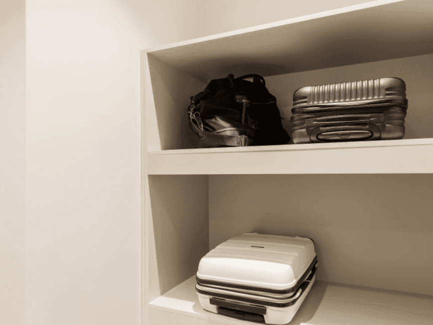 Items of Luggage on a white shelve at Brady Apartment Hotel Flinders Street