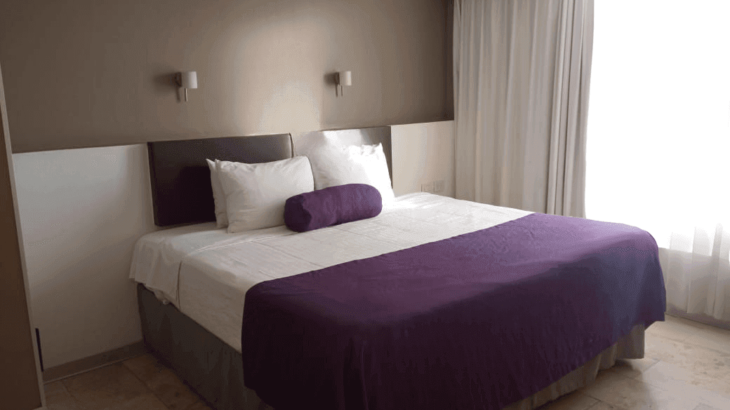 King bed, comfy pillows, blanket, wall lamps & curtains in Deluxe Room, 1 King at Gamma Puebla Señorial Centro