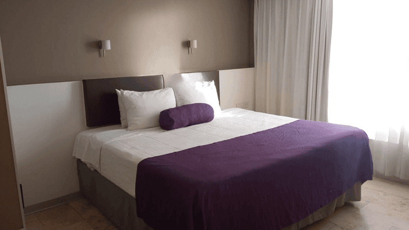 Comfy bed and wooden floor in Deluxe Room, 1 King at Gamma Puebla Senorial Centro