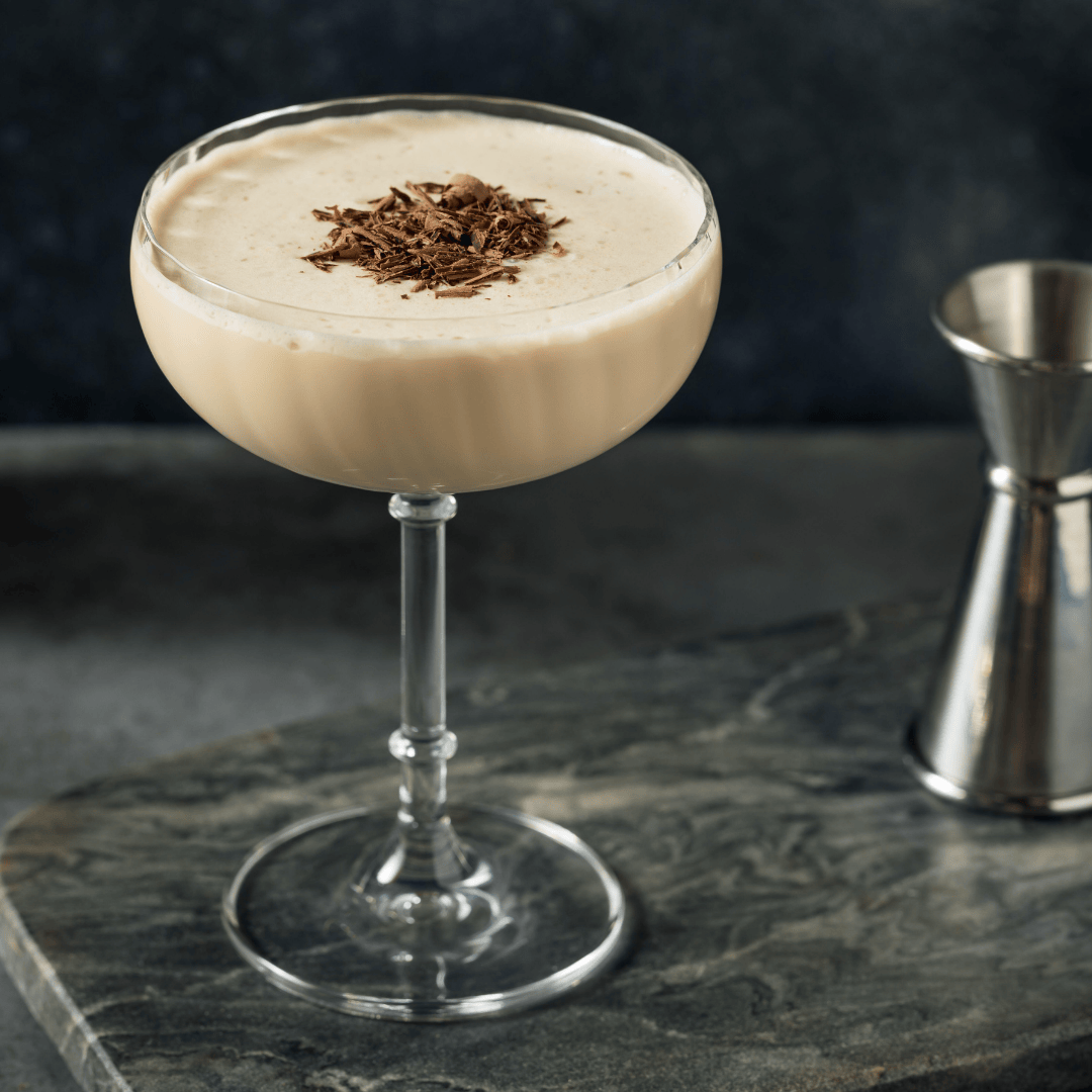 An espresso cocktail topped with bits of chocolate.