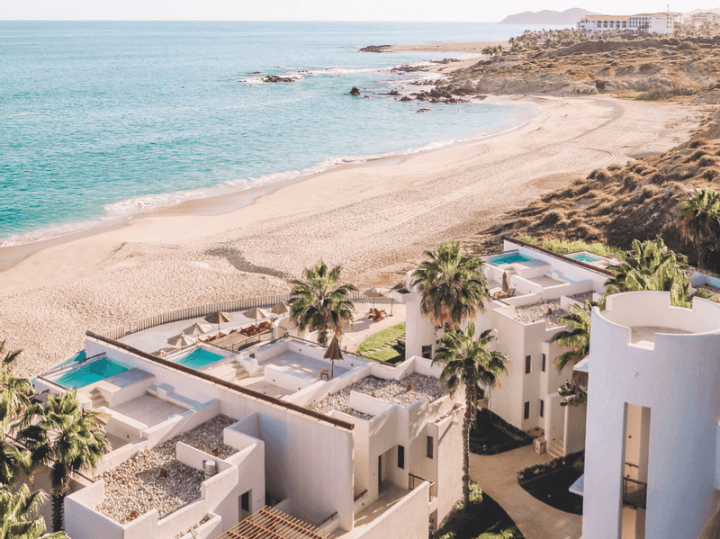 Overlooking luxurious suites with private pools by a tranquil beach at Marquis Los Cabos Resort