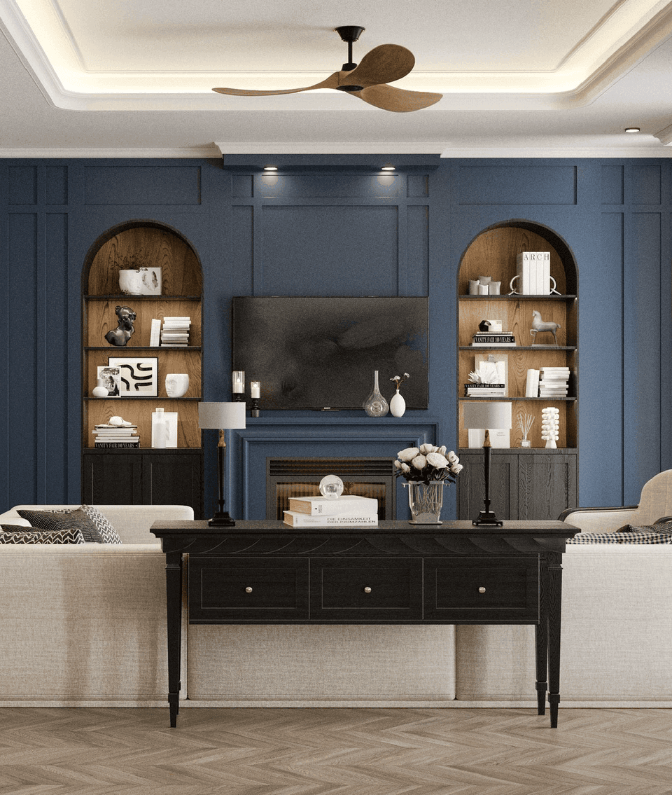 Luxurious lounge area at A'ila Resorts, with a blue fireplace, built-in shelves, and a large TV