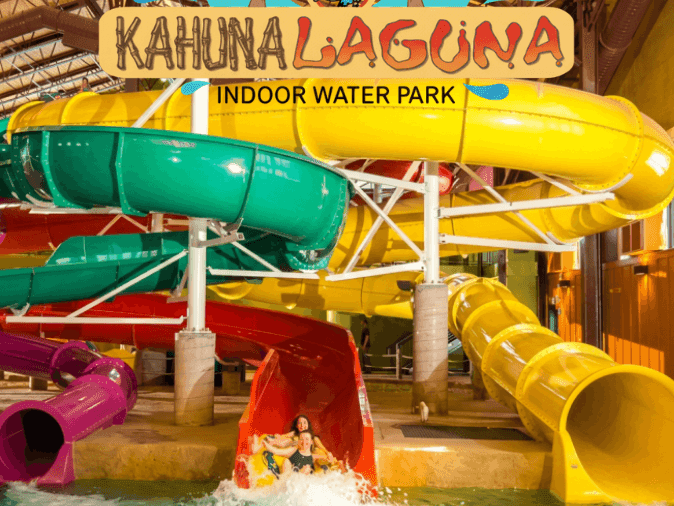 Colorful water slides and splash pool at Kahuna Laguna Indoor Water Park with guests enjoying the attractions.