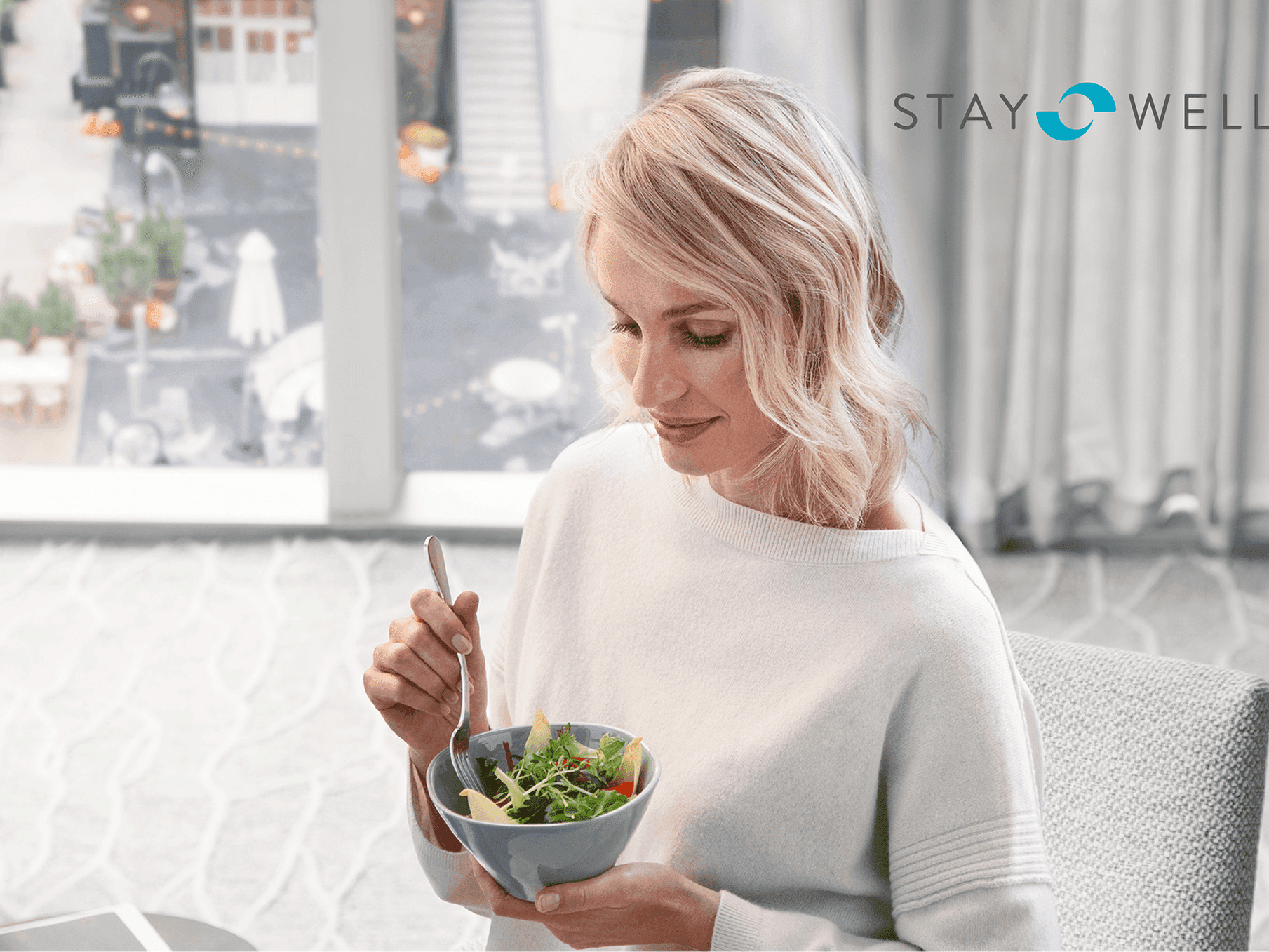 Woman with a cup of salad at The Godfrey Boston Hotel