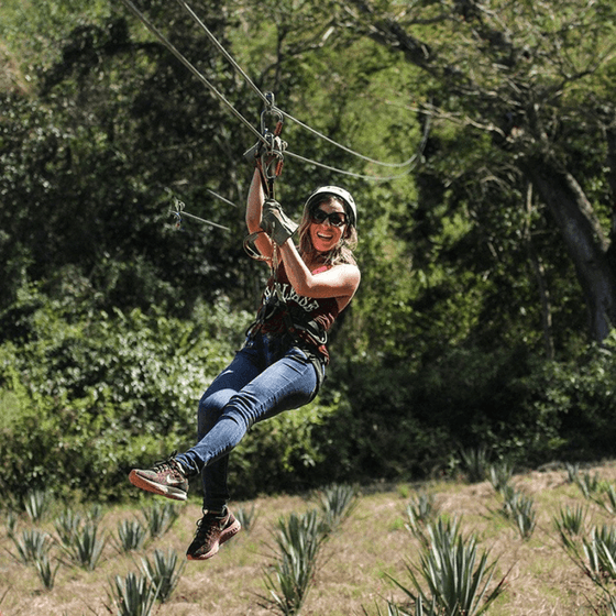 A lady enjoying a Zip line ride near Viaggio Resort Mazatlan