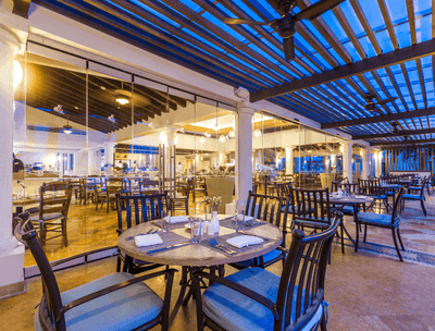 Dining tables set for dinner in Frutas y Flores Restaurant at Buenaventura Grand Hotel and Spa