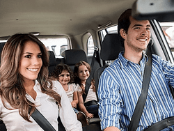 A happy family in a car at Routes Car Rental near Acclaim Hotel Calgary