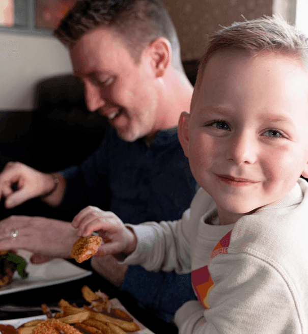 Family dining in Tonic Kitchen + Bar at Hotel Clique Calgary Airport