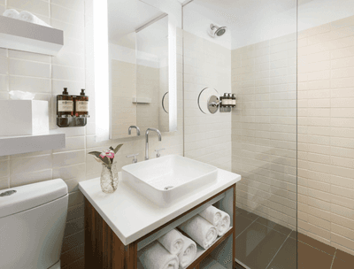 Bathroom with shower area, vanity & amenities in a guestroom at The Verb Hotel
