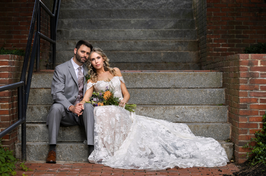 A Bride and Groom posing by a stairway at The Exeter Inn