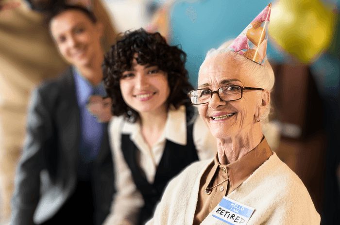 Colleagues and retiree celebrating milestone retirement party at Gorse Hill in Surrey 