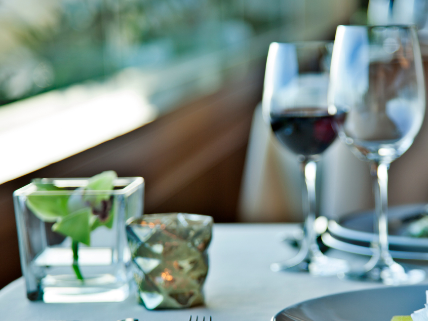 Close-up of table with wine & dishes at Hotel Cascais Miragem