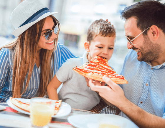 Family eating pizza at a restaurant in Cape May, NJ