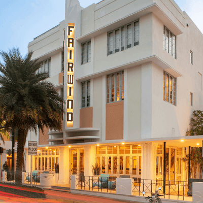 Exterior view of the Hotel building and the sign board of Fairwind Hotel Miami