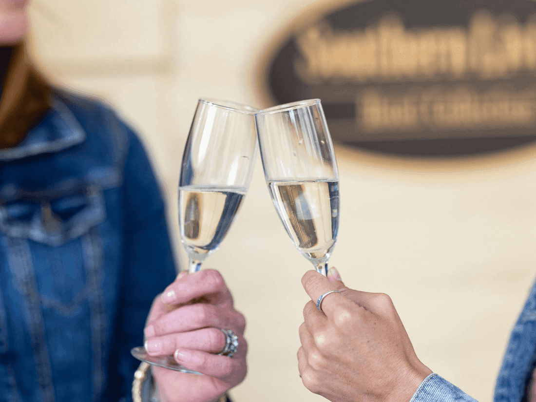 Two People Toasting with Glasses in the Inn at Willow Grove