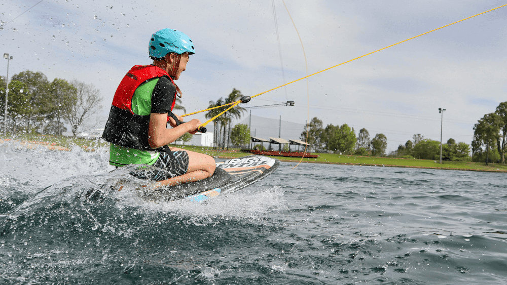 Wakeboarder in action with cables above at Cables Wake & Aqua Park.