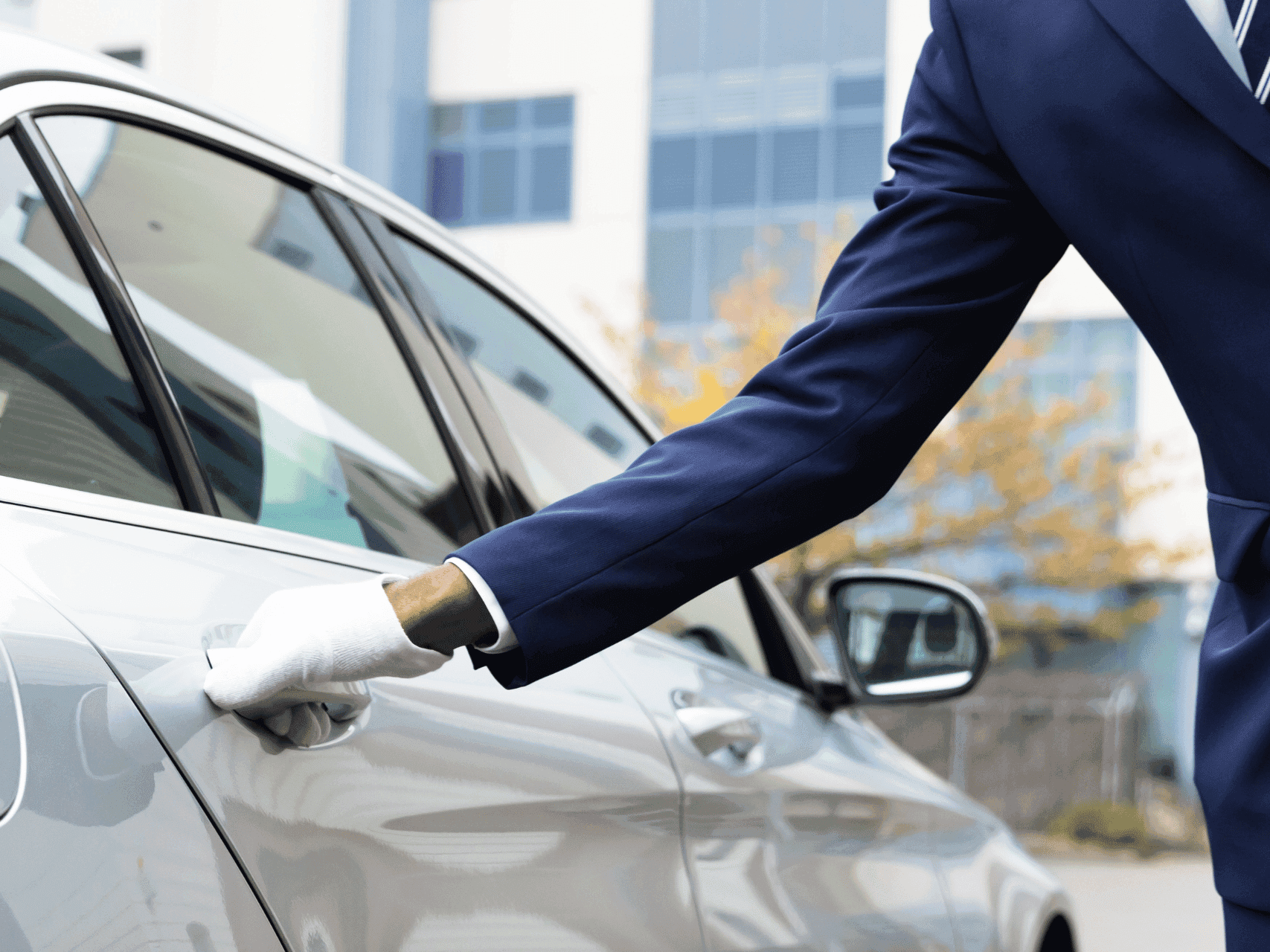 Closeup of a taxi driver opening the door for Valet parking service at