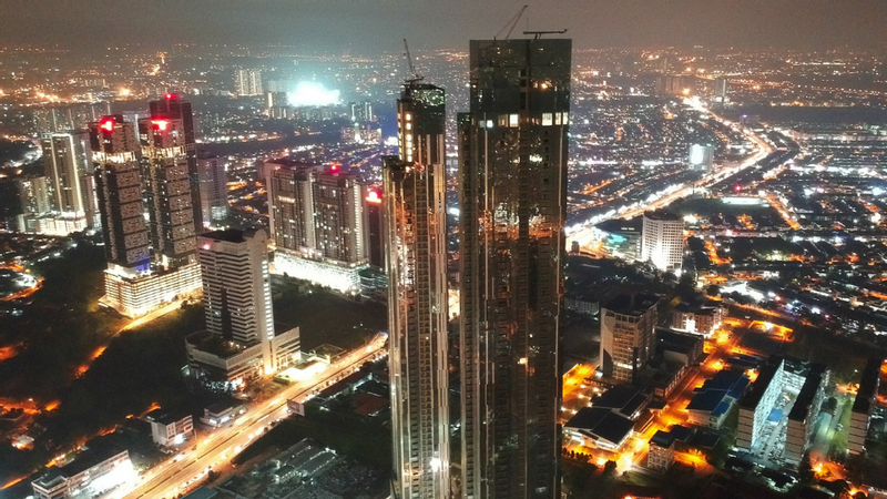 Aerial night view of a cityscape with illuminated skyscrapers and busy street at Sunway Hotel Big Box
