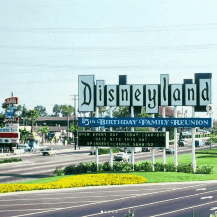 Disneyland's 25th Birthday Family Reunion sign on road with cars and greenery at Grand Legacy at The Park Anaheim