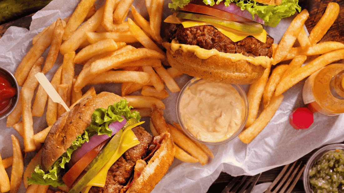 Two cheesy burgers with fresh toppings and golden fries served at Novotel Sydney International Airport