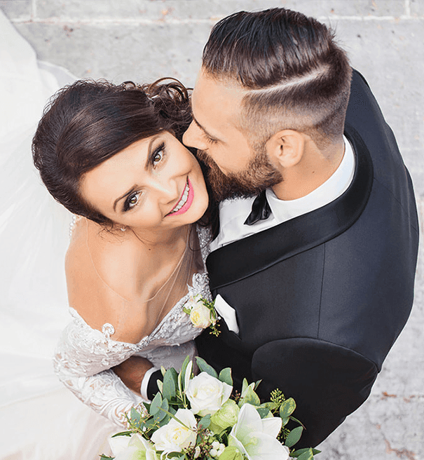 High-angle view of a wedded couple posing at Hotel Clique Calgary Airport