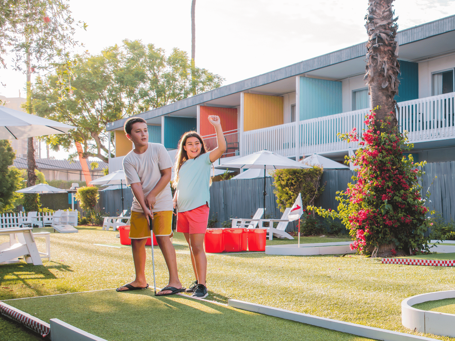 Kids playing mini golf at The Anaheim Hotel's recreation area. 