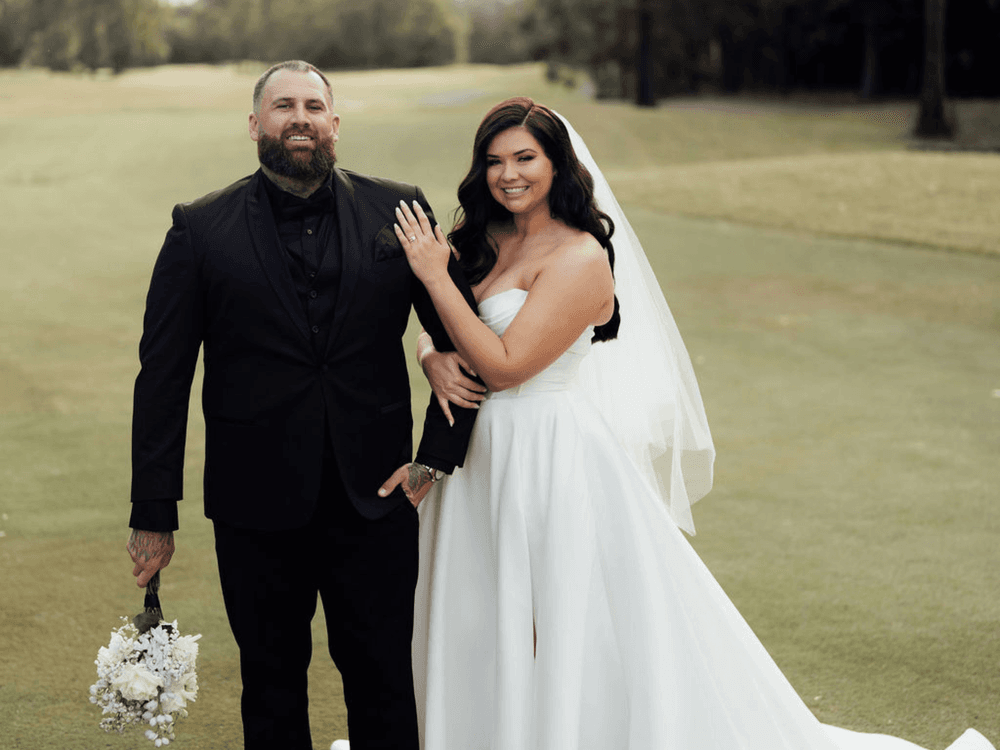 Bride and groom posing for a picture on a golf course for Planning a Destination-Style Wedding Without Leaving NSW blog.