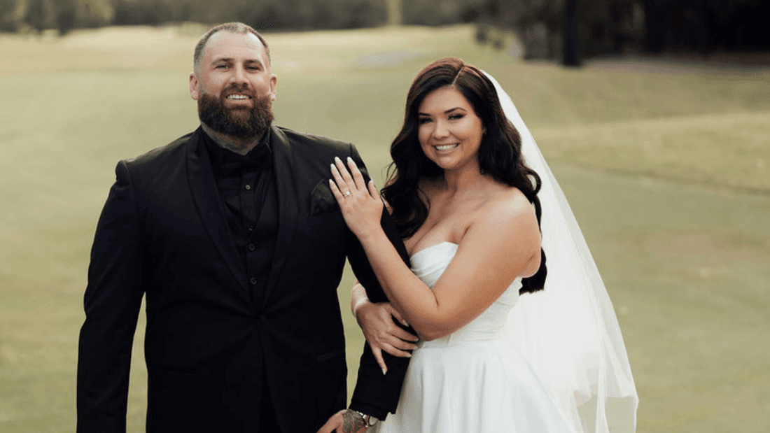 Bride and groom posing for a picture on a golf course for Planning a Destination-Style Wedding Without Leaving NSW blog.