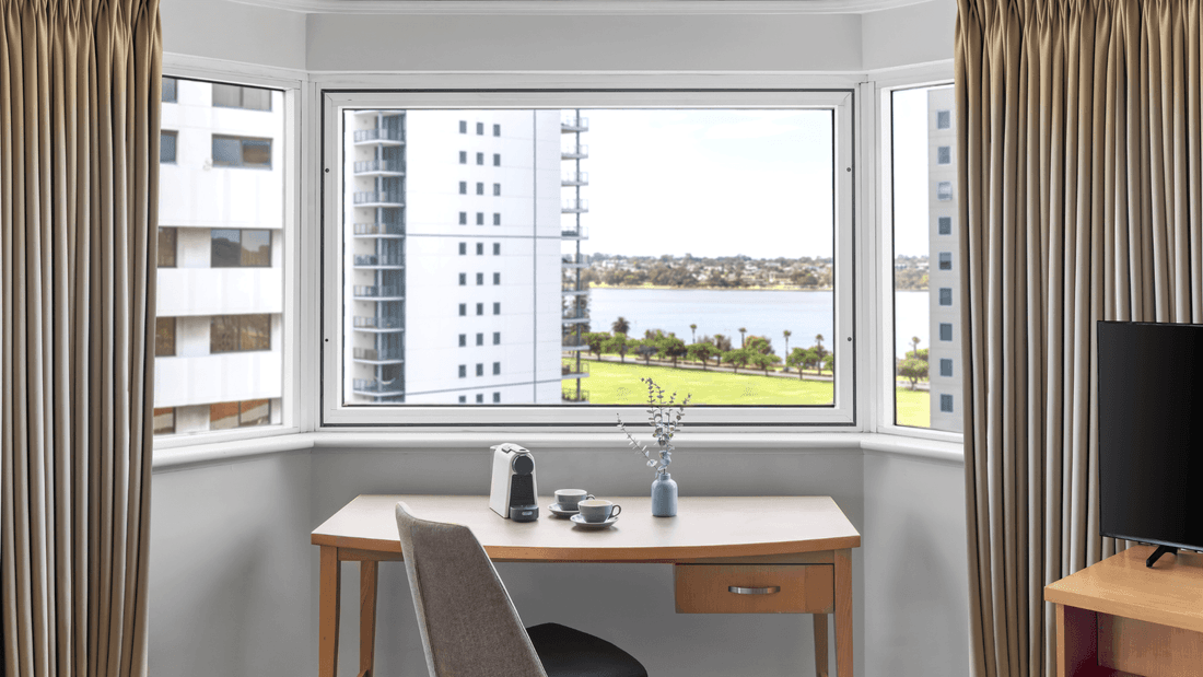 Junior Suite at Novotel Perth Langley offers a living area and a work desk overlooking the stunning Swan River views