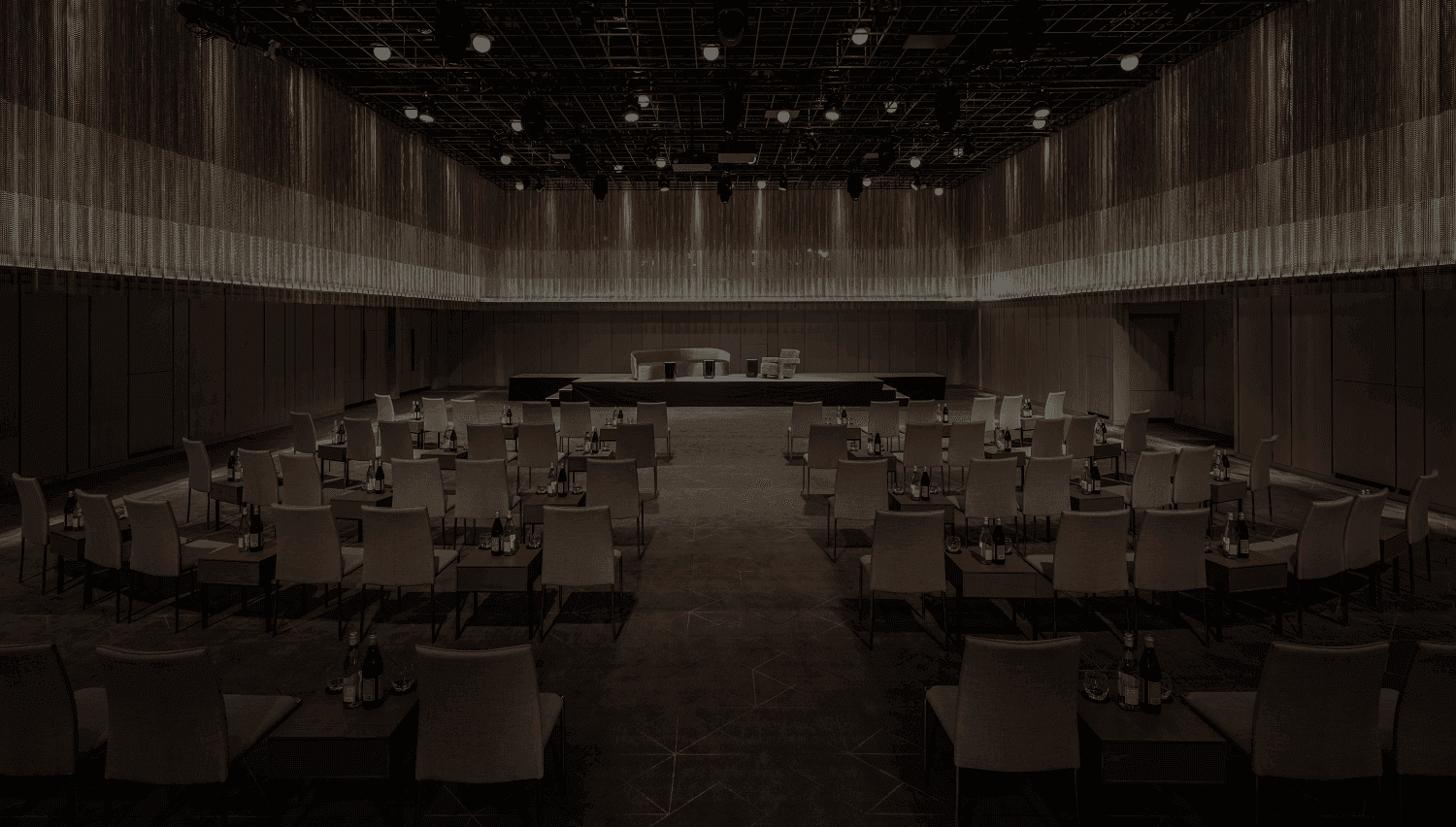 Spacious Theatre style Ballroom with neatly arranged chairs and elegant lighting at The Londoner Hotel