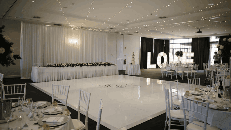 Kooindah Ballroom setup for wedding with tables, and white decor at Mercure Kooindah Waters