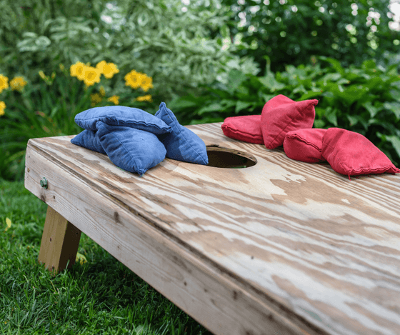 Cornhole boards and bean bags set up outdoors at Anchorage By The Sea