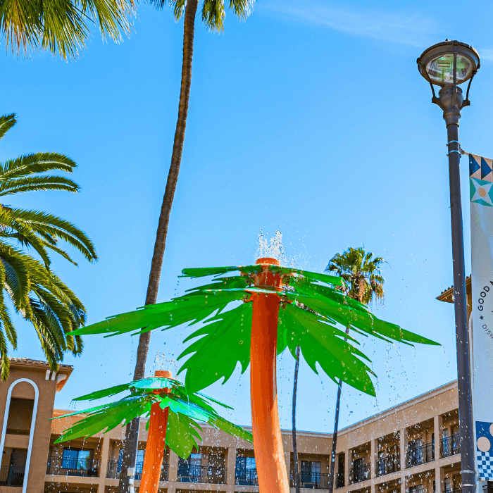 a picture of the hotel building with palm trees