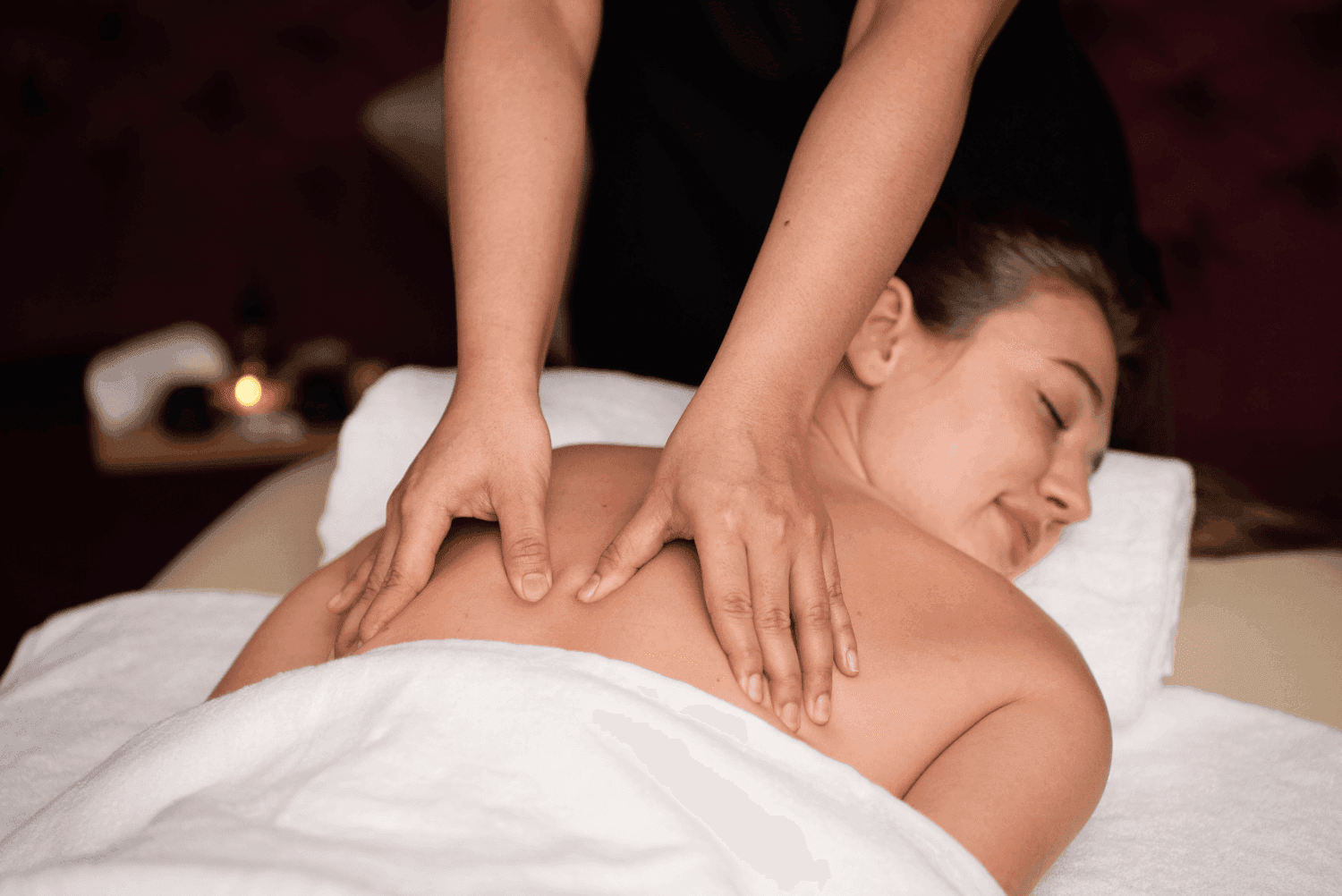 Luxurious back massage with soothing ambiance offering ultimate spa relaxation in Dreamworks Spa at DAMAC Maison Distinction
