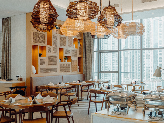 Dining tables arranged in CineScope Restaurant at Paramount Hotel Midtown