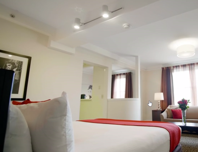 A large bed in a Deluxe Studio Room at Artmore Hotel
