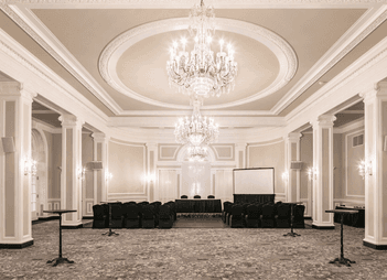 Chairs arranged in rows under large crystal chandeliers at Rodd Charlottetown Hotel, one of the best hotel in PEI