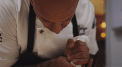 Chef garnishing a meal with concern at The Abbey Inn