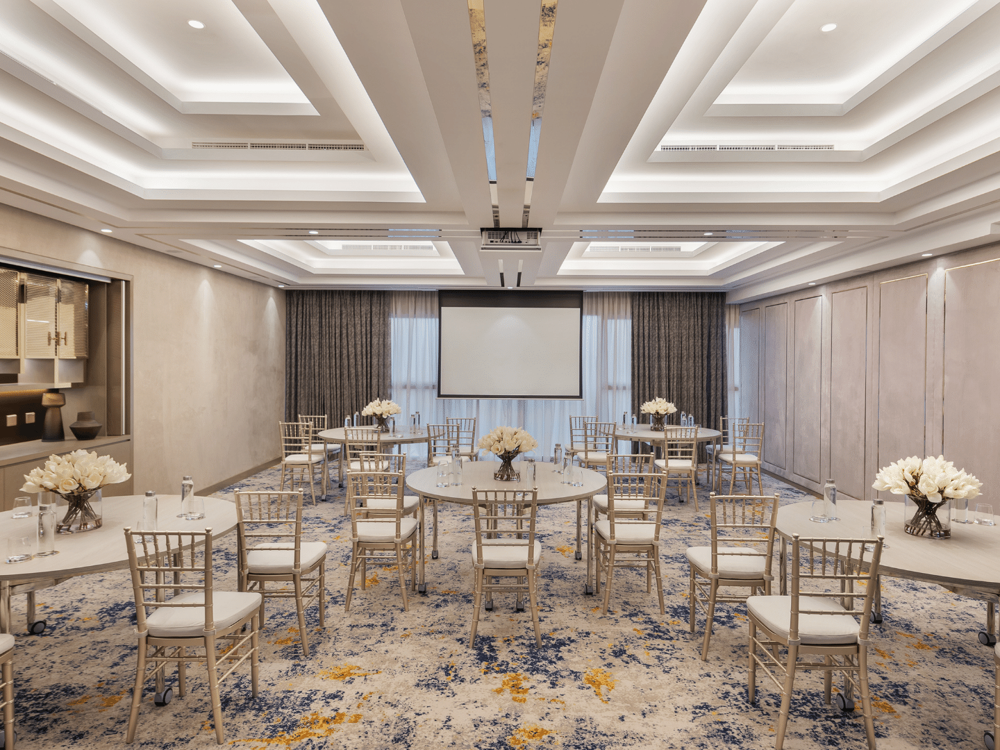 Meeting room with tables, chairs, and a projector screen in Business Studio 1 at Paramount Hotel Midtown