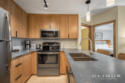 Kitchen in a suite at Falcon Crest Lodge features stainless steel appliances and a breakfast bar